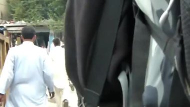Following Backpacker In Busy Street - Slide Forward
