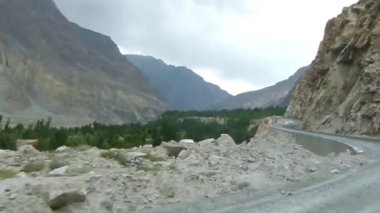Driving Past Mountains And Gravel - Slide Left To Right, And Pan Right To Left