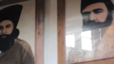 Leader Of Agha Khan Pictures Framed On Wall From Below - Pan - Left To Right