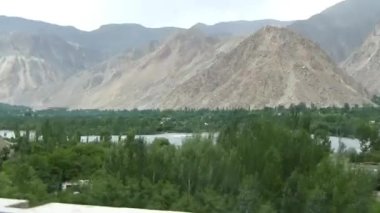 Moutains And Gravel Near Road - Slide And Pan - Left To Right 