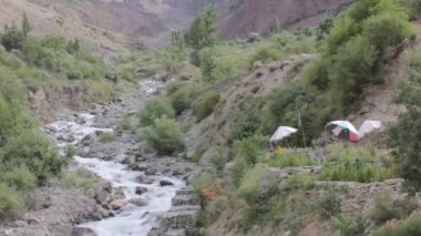 Water Source Flowing Near Sun Shades And Flora - Static