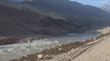 Driving By Water Source And Mountains - Slide - Left To Right