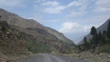 Turning Left While Driving Surrounded By Mountains - Slide Forward 