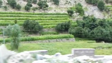 Passing By Blocks Near Road And Flora On Mountains - Slide - Left To Right 