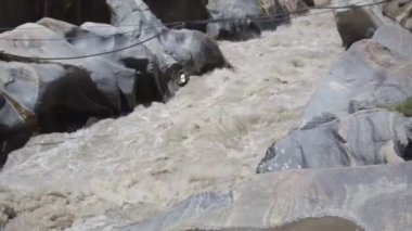 River Water Source Flowing Surrounded By Rocks - Static