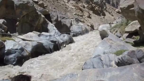 Boys Sitting Rocks River Water Source Flowing Pan Right Left — Stockvideo