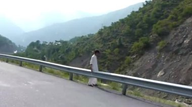 Passing By Man And Rocks Near Road And Mountains - Slide - Left To Right