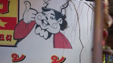 Drawing  Of Chef On Wall Near Decoration Hanging In House - Slide - Left To Right
