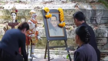 People Praying For Lost Loved One In Front Of Picture - Handheld