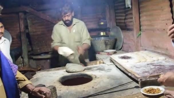 Men Eating Preparing Dinner Man Flattening Bread Doe Putting Oven — Stockvideo