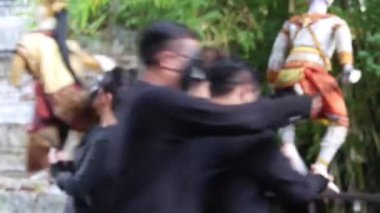 People With Masks Dancing In A Circle With Traditional Puppet - Handheld  