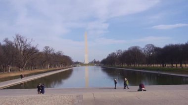 Monument Behind Water Source And People - Static