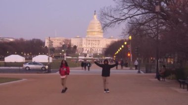 People Walking With Arms Wide Open In Street Near Monument - Static