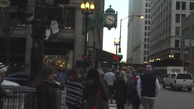 People Walking In Street Near Clock - Static - Slow Motion
