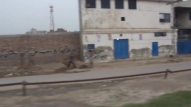Passing By Houses, Brick Wall And Trucks - Slide And Pan - Right To Left