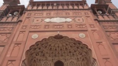 People Near Mosque Entrance - Tilt - Up To Down