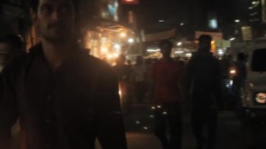 People Walking And Motorbike In Busy Street At Night - Pan - Right To Left