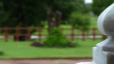 Pillar In Front Of People Walking Barefoot On Wet Floor After Rain - Pan - Right To Left
