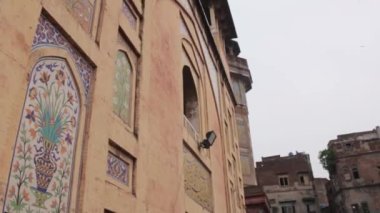 Painting On Wall And People In Street - Tilt - Up To Down