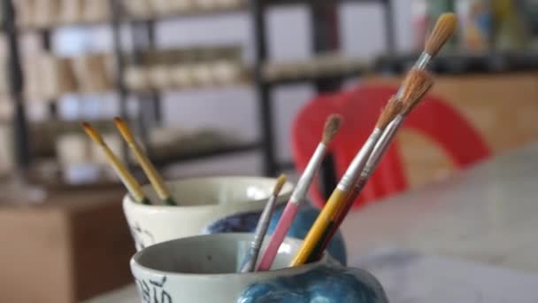 Paint Brushes Pottery Cup Container Slide Right Left — Stock Video