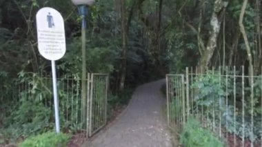 Gates To Clobbes Alley Way Surrounded By Flora - Slide Forward.