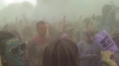 Crowd Dancing Under Colorful Powder In The Air - Pan - Left To Right.