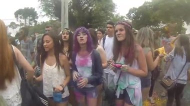 Walking By Cool People Dancing In Crowd Covered By Colorful Powder - Walking Forward.