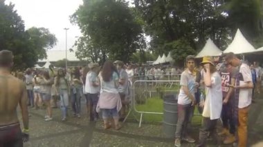 Walking Past People Covered By Colorful Powder - Walking Forward.