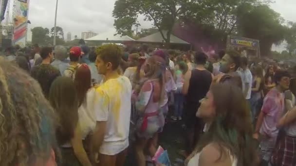 People Covered Colorful Powder Dancing Front Stage Slide Left Right — Stockvideo