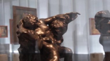Bronze Statue Behind Exposition Glass Reflecting Man Walking By - Slide Left To Right, Then Right To Left