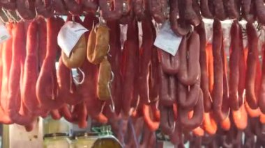 Meat Sausages Hanging Spinning Around In Butcher's Stand In Indoors Market - Static