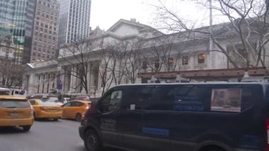 Taxis And Cars On Road Surrounded By Buildings - Pan - Right To Left.