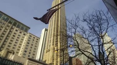 American Flag In The Wind In Front Of Buildings From Below - Static