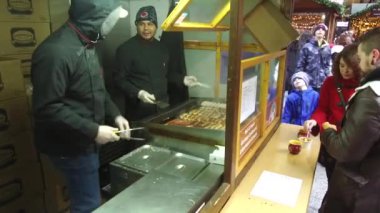 Vendors Talking And Cooking Food At Market Stand - Handheld