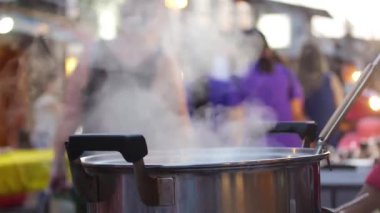 Steam Coming Out Of Cooking Pot In Front Of Busy Street - Static