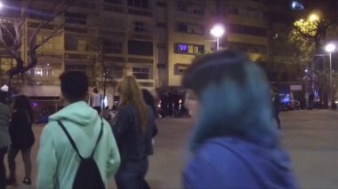 Geceleri meydanda yürüyen insanlar - Pan - Sağdan sola.