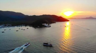 Beautiful Sunset With Speed Boats Going In The Water Around Islands - Aerial View