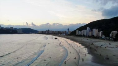 Silhouette of a Beautiful City with mountains by The Beach - Aerial View