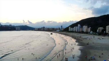 Silhouette of a Beautiful City with mountains by The Beach - Aerial View