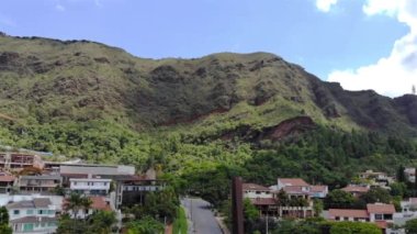 Modern Houses in front a Green Tropical Mountain - Aerial View - Dolly Left.