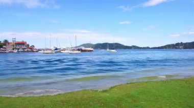 Pan from a beautiful lake view to the side walk.