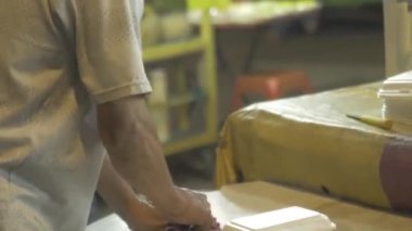 Old malay uncle selling durians at a night market in Kuala lumpur - Malaysia