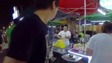Person selling boiled corn at a night market in kuala lumpur ,malaysia.