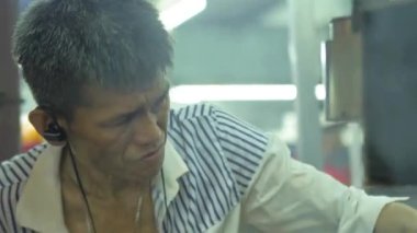 Closeup of Chinese man cooking chicken wings