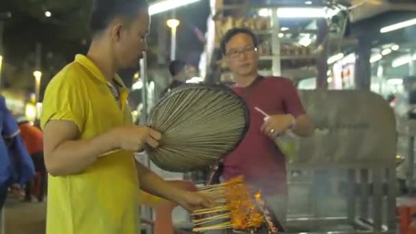 Asian Man Yellow Shirt Making Satay Sticks Bbq Grill Night — Stockvideo