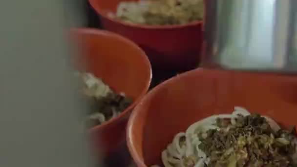 Asian Guy Putting Dry Spice Red Beef Noodle Bowls Chopsticks — Stockvideo