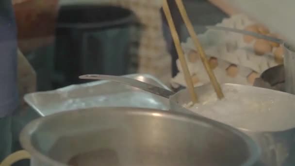 Asian Man Cooking Noodles Big Silver Pot Huge Chopsticks — Stockvideo