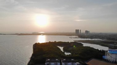  Gökyüzünde deniz ve şehirle birlikte güneşin en güzel manzarasının havadan görünüşü.
