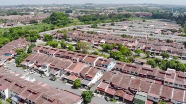 Top Aerial View Of Housing And City In Malaysia With Beautiful Mountain Views and Trees