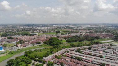 Top Aerial View Of Housing And City In Malaysia With Beautiful Mountain Views and Trees